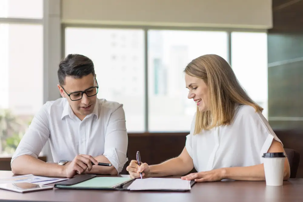Couple signing a Statutory Declaration of Common Law Union (IMM 5409) form at a notary office in Scarborough